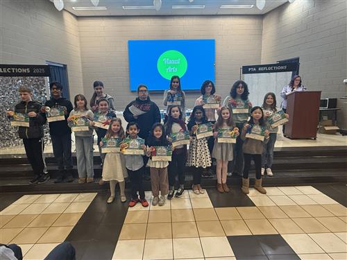 group of 17 students holding awards in Visual Arts